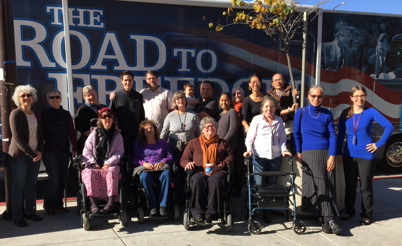 DREDF staff pose in front of The Road to Freedom Bus in Berkeley, California.