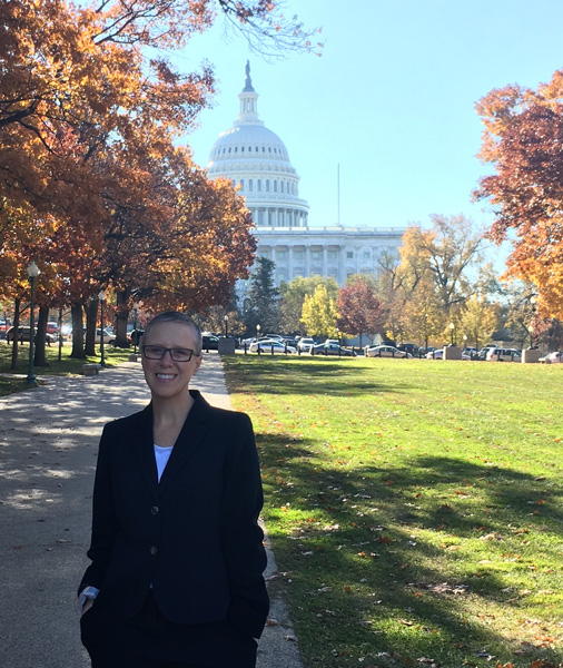 Carol Tyson outside on fall day with the U.S. Capitol Building in the background.