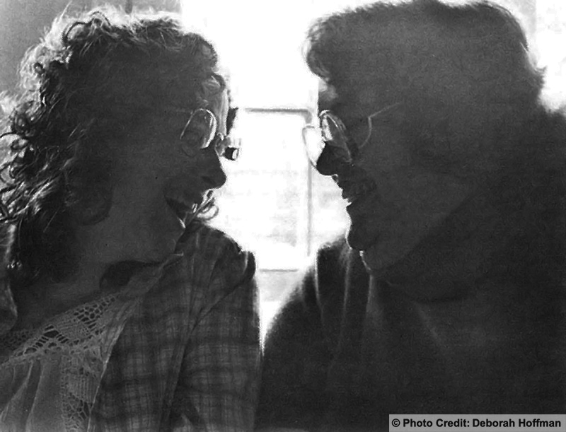 Two women sitting closely together talking and smiling. Photo credit: Deborah Hoffman
