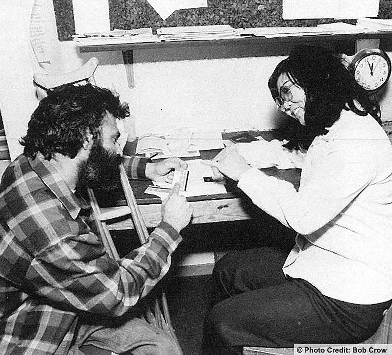 A woman in her office is signing to the man she is counseling. Photo credit: Bob Crow