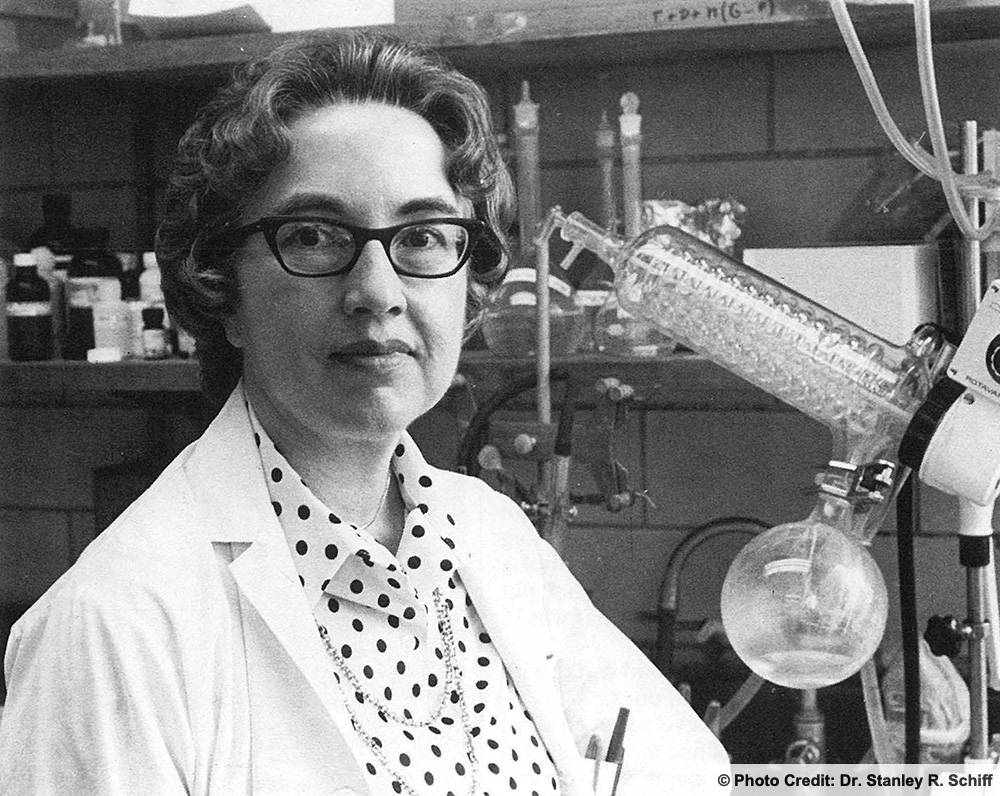 Dr. Schiff in her lab wearing a white lab coat.