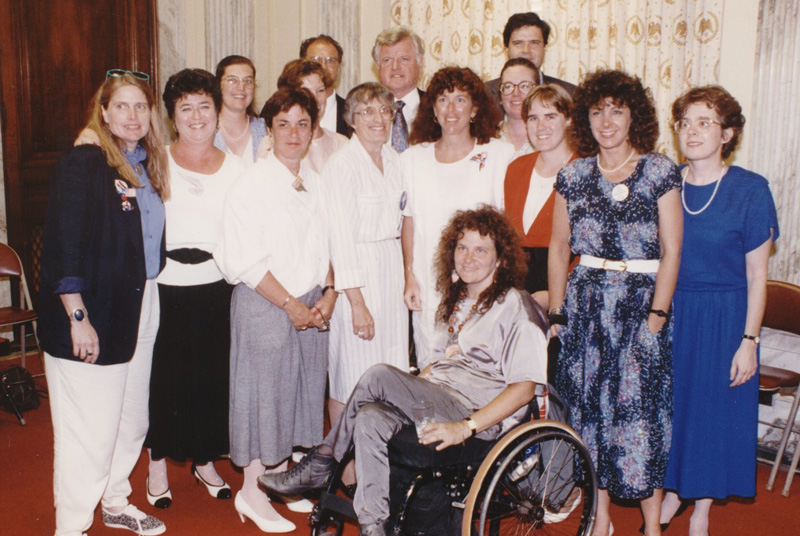 Large group photo. Arlene Mayerson and Ted Kennedy in center