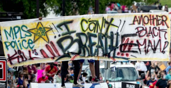 Large crowd. Signs that say I can't breath, another black man and black lives matter