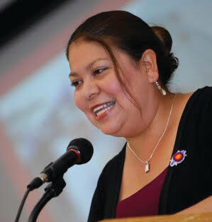 Rain Marshall speaking at a lectern with the ACLU and Northern California Indian Development Council logos