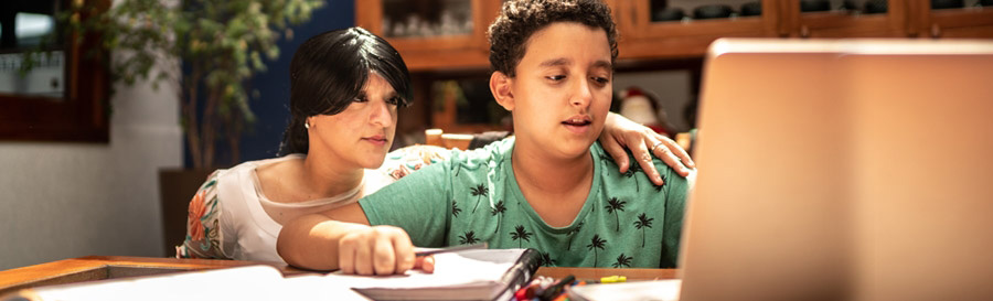 Child at a computer with adult helping