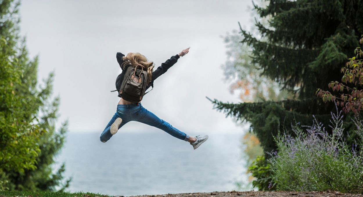 Young woman jumping for joy.