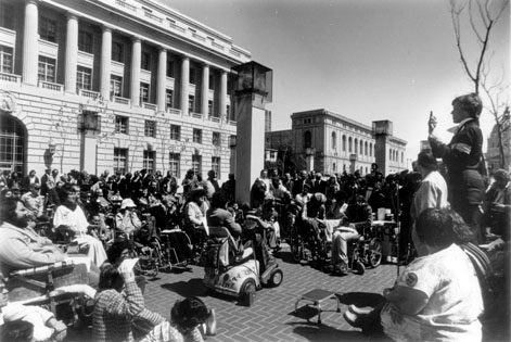 Black and white photo from 504 Sit-Ins of protesters in San Francisco outside of the HEW building