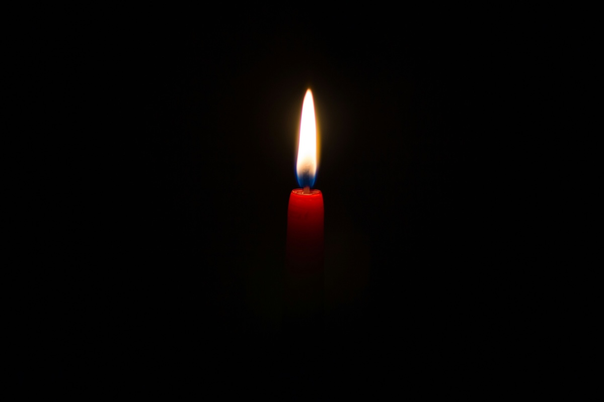 A red candle on a dark background