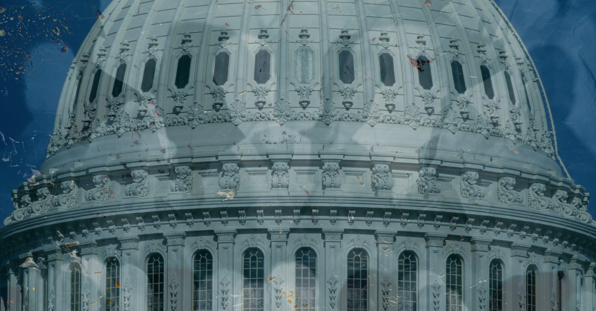 Exterior of the Capitol rotunda with dark figures across it