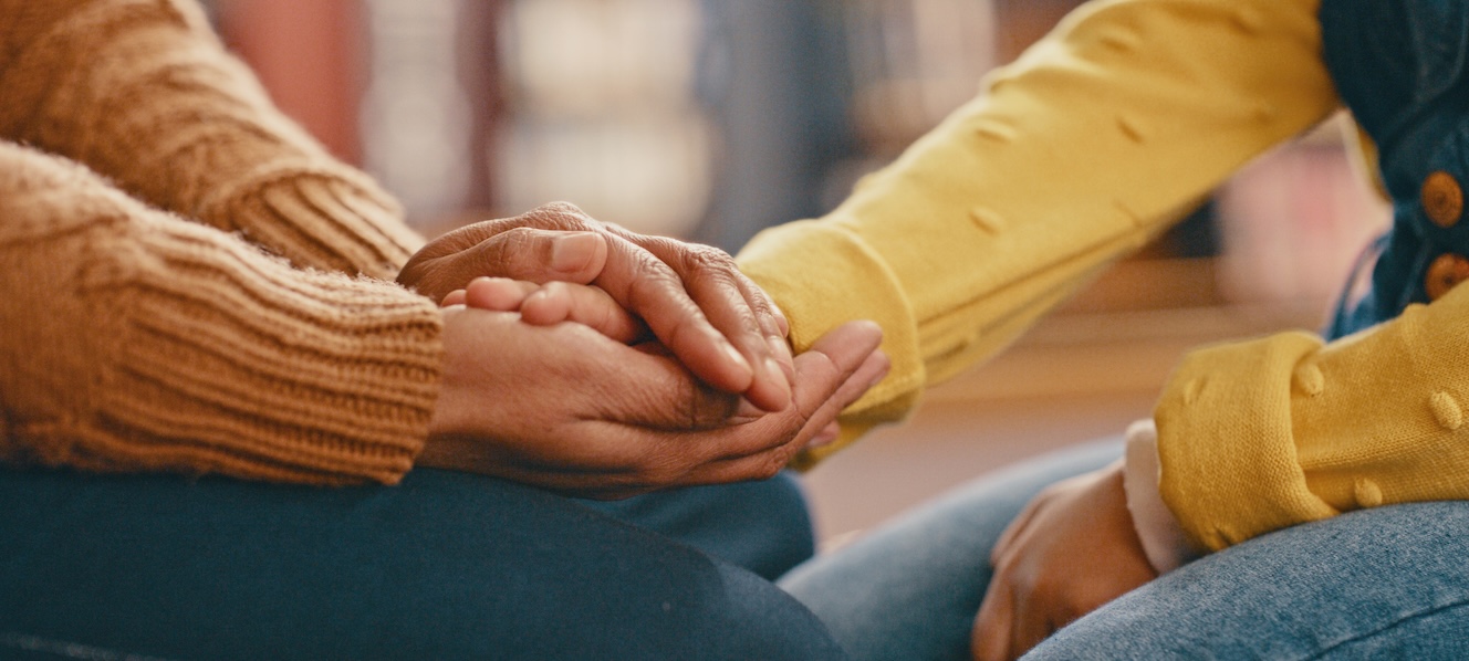 Close up of two people holding hands