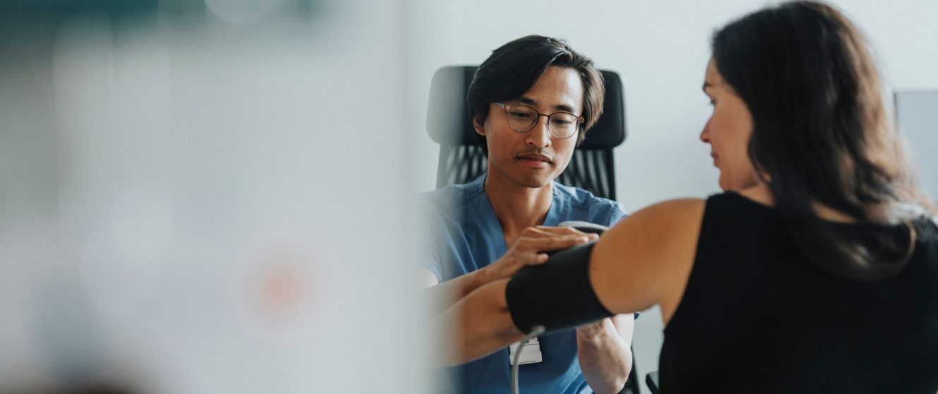 A doctor checking blood pressure of a patient