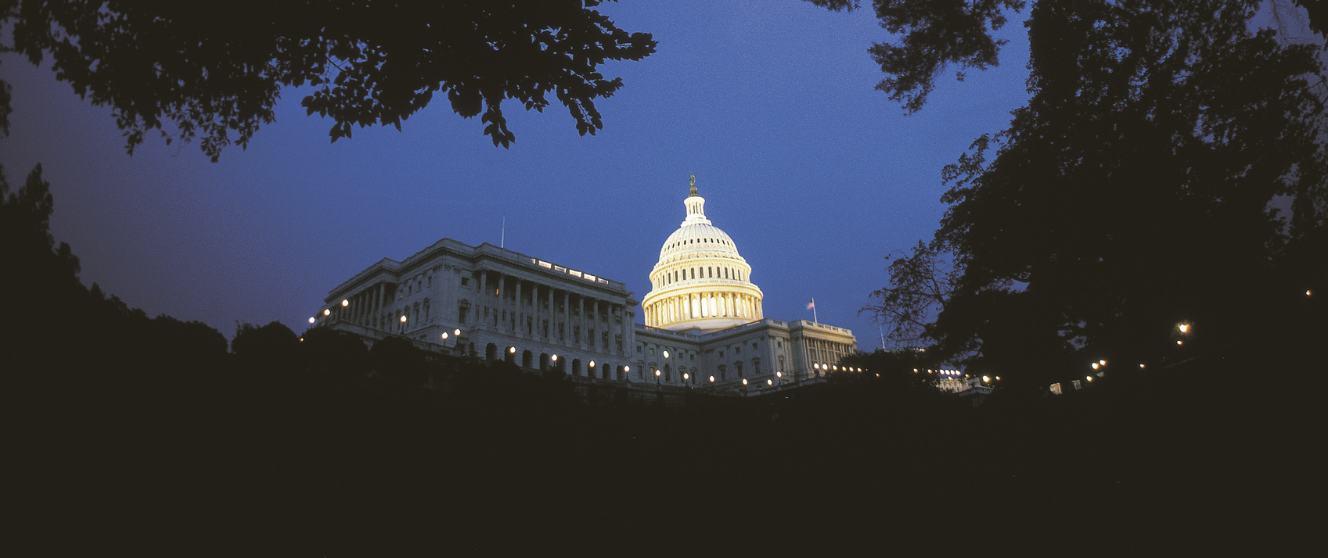 Exterior of U.S. Capitol building lit up during the evening
