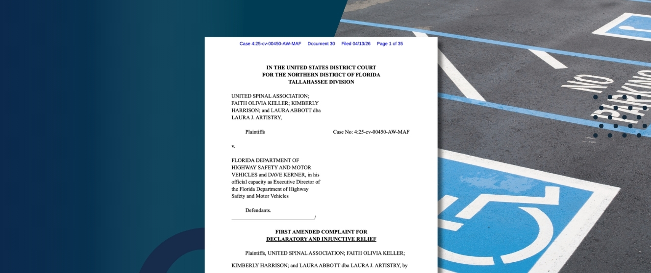 An empty disability parking space with the front page of the complaint