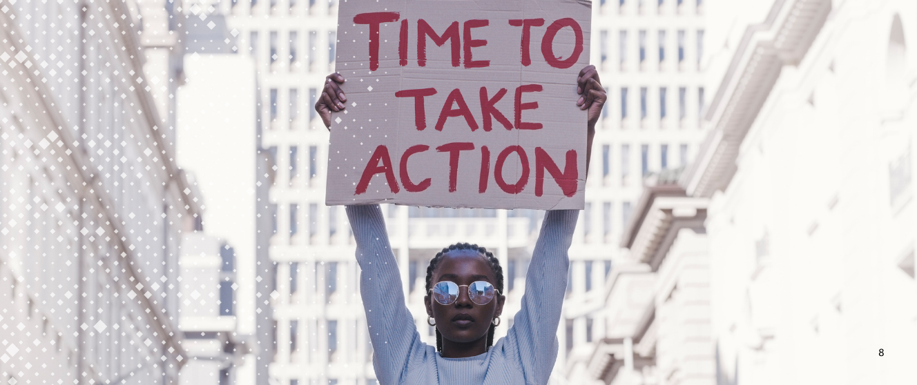 A person holds up a sign that reads 