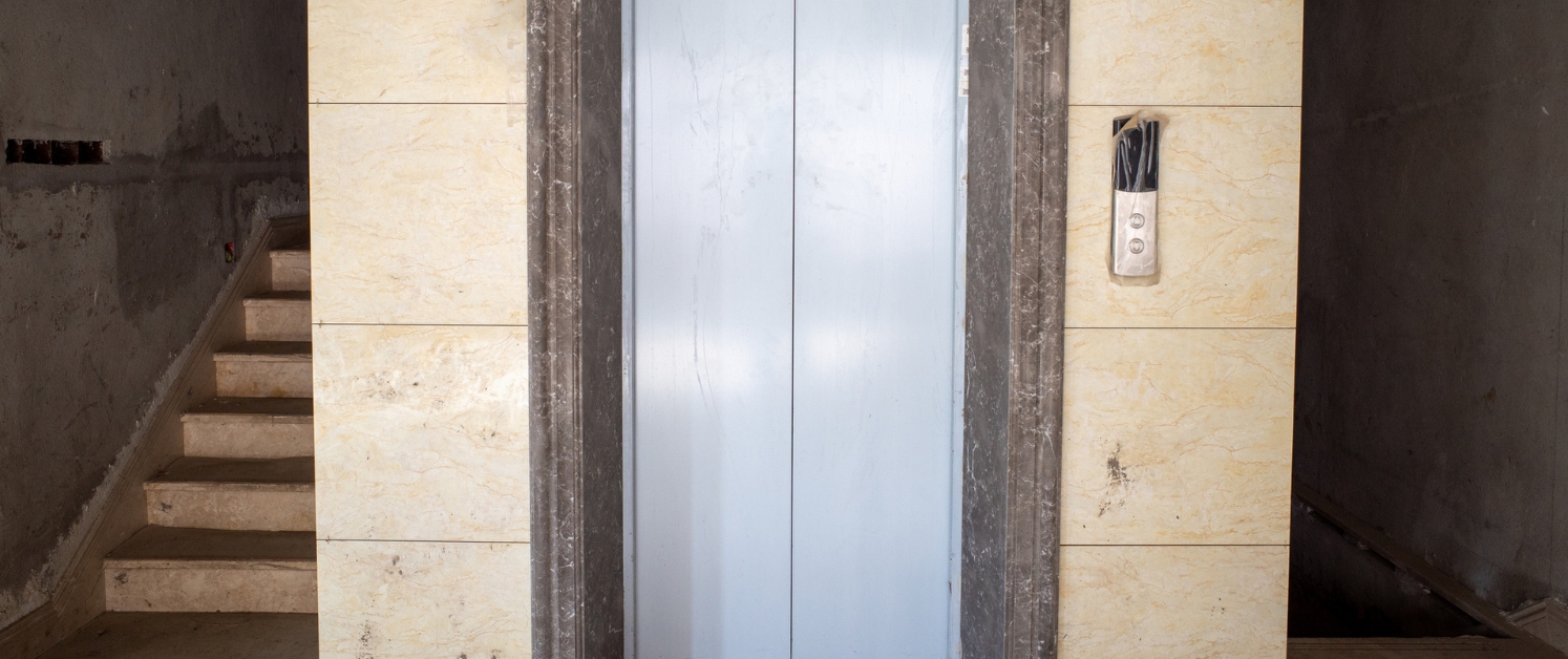 Elevator in an older building with marble framing