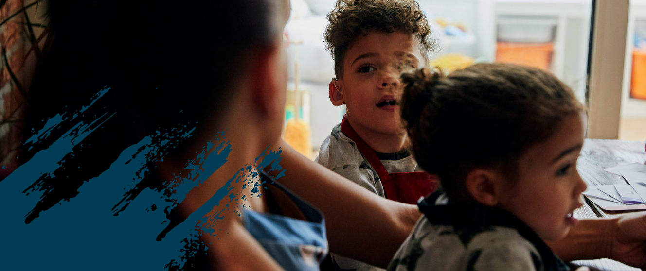 A young student with a hearing aid looks up to an adult, Decorative brush-stroked sweeps.